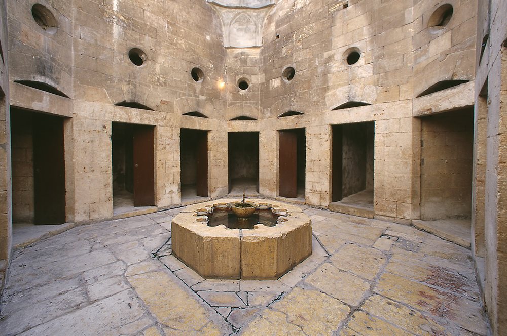 <p><i>Above and right: </i>Fountains were central to the architecture of the Bimaristan Arghun: Three courtyards each held a fountain, around which patient rooms were arranged, while the central courtyard featured a large rectangular pool and well. (Since these photos were taken, <span class="smallcaps">unesco</span> has listed the bimaristan as damaged by warfare.) &nbsp;</p>

