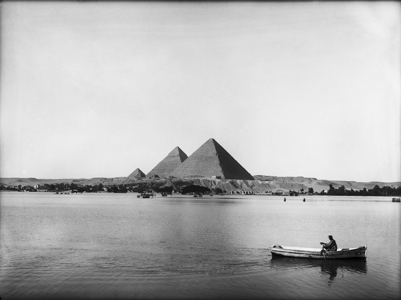 In October 1927 Ibrahim photographed this boatman crossing inundated fields just east of the Giza Pyramid Complex during the annual Nile flood, an event that ended in the 1960s with the completion of the Aswan High Dam.