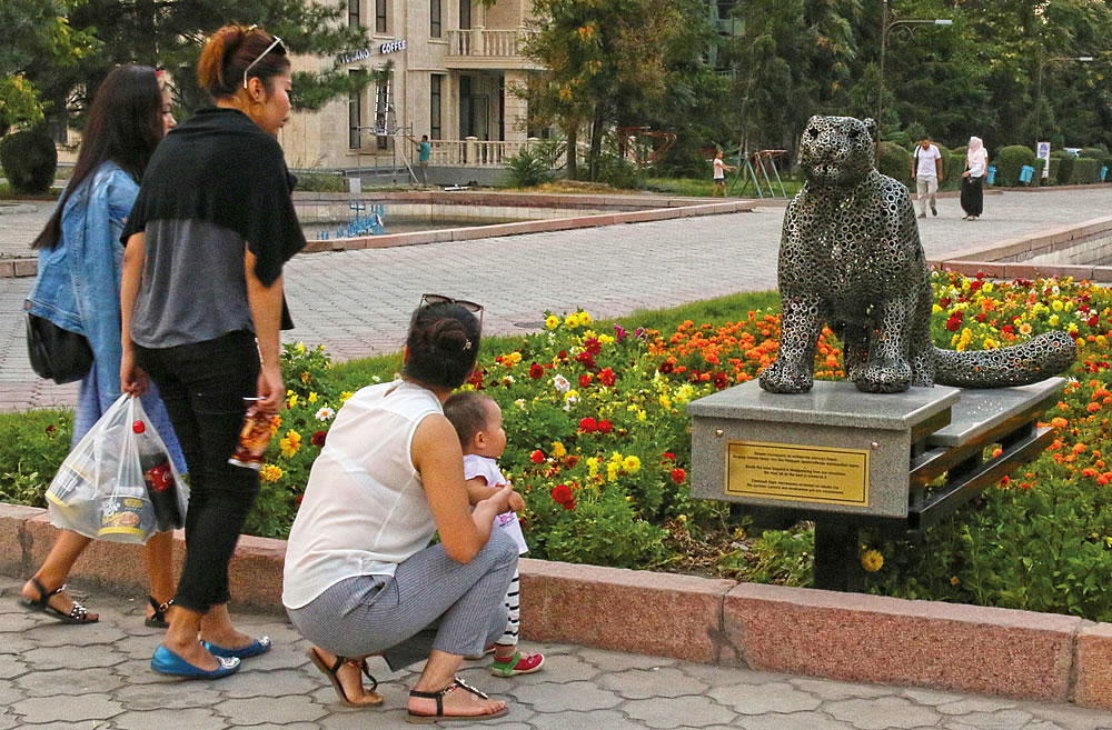 In central Bishkek a family stops to look at artist Nikolai Cherkasov&rsquo;s life-size sculpture of a snow leopard, commissioned to accompany the International Snow Leopard and Ecosystem Forum. The plaque beneath it reads, in Kyrgyz, Russian and English, &ldquo;Slowly the snow leopard is disappearing from our mountains. We must all do the best to conserve it.&ldquo;