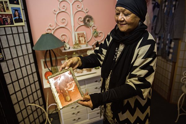 At her home in the Bo-Kaap neighborhood of Cape Town, Abdiyah Da Costa, 92, shows a photo of herself during younger years. Known as the Malay Quarter, Bo-Kaap dates back to the 1760s when Dutch colonist Jan De Waal leased homes to his slaves, who were mostly Malay Muslims.