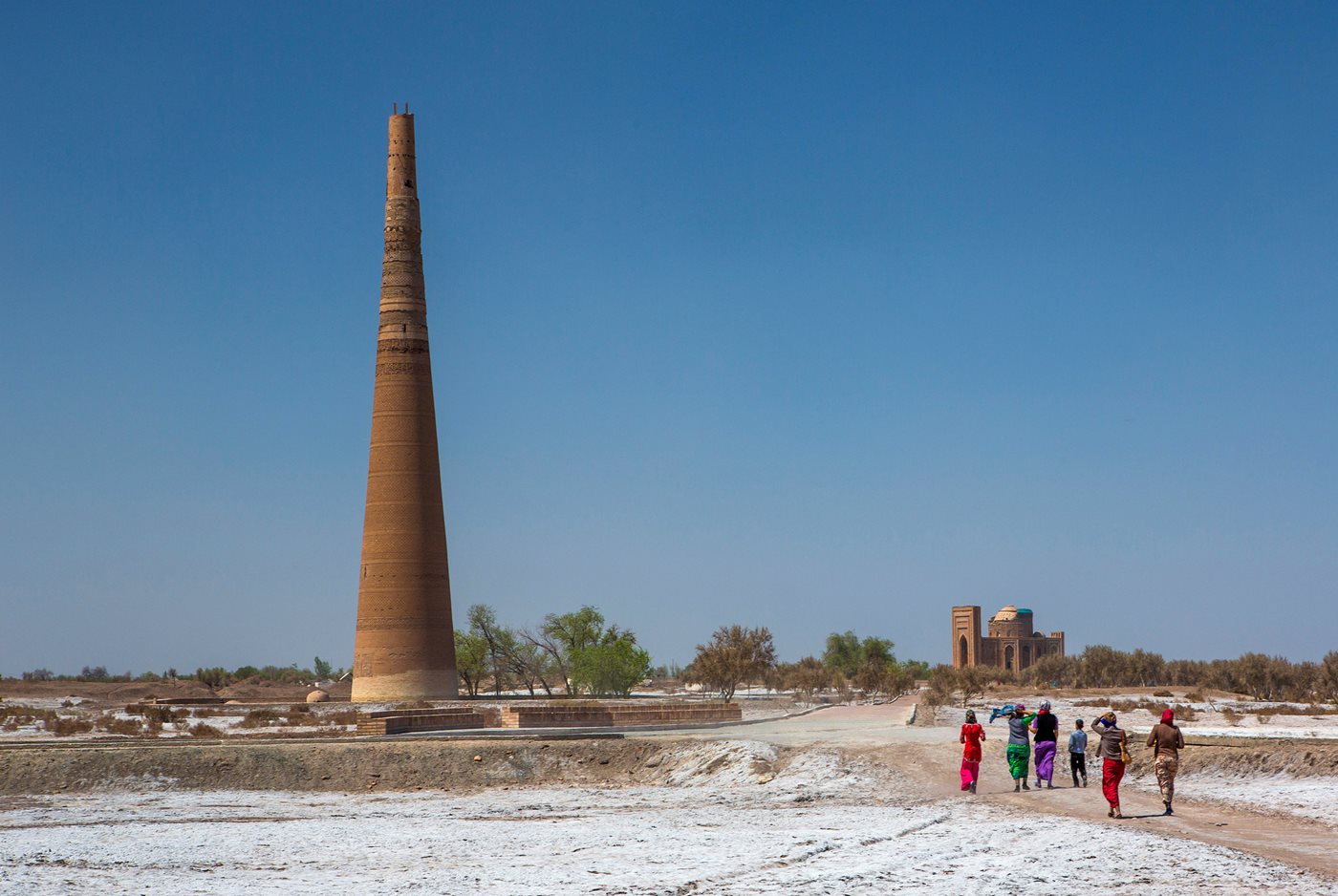 Visitors to monuments at Konye Urgench head toward the Qutlug Timur Minaret and the adjacent site honoring his wife, Tura Beg Khanum.