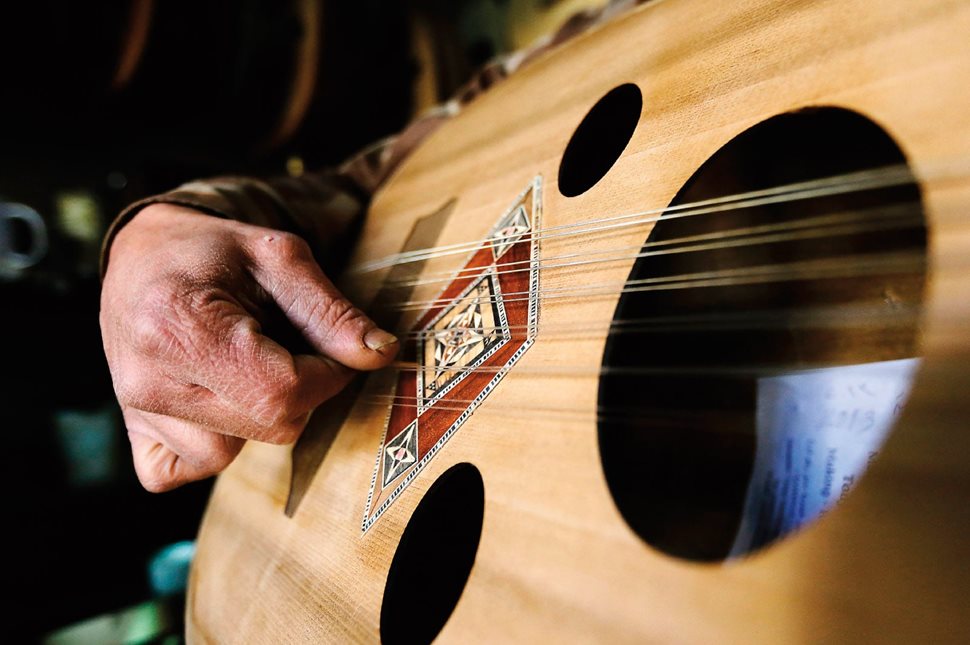 ‘Ud maker Antoun al-Tawil plays an ‘ud at his shop in Damascus, Syria. The bridge lifting the paired strings off of the soundboard allows the strings to be strummed and plucked with a plectrum—the same way lutes were played some 4,000 years ago. 