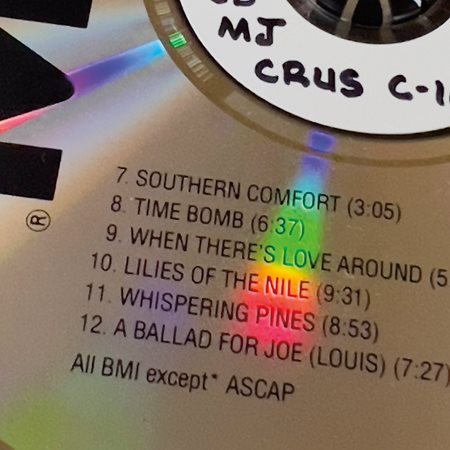 A close-up of a list of tracks on the CD re-release of the 1974 album Southern Comfort, by The Crusaders, a jazz fusion band that disbanded in 2010 after 50 years of playing together, reveals a track list that included the song “Lilies of the Nile.”