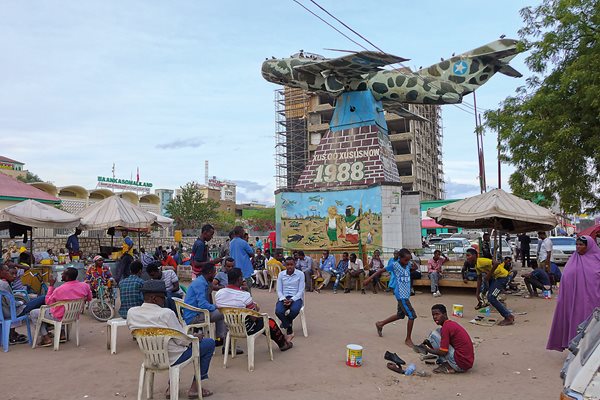 Hargeisa residents gather and relax around Freedom Square&rsquo;s war memorial, a downed Somali Air Force MiG-17 mounted atop a mural of a woman holding Somaliland&rsquo;s flag. Since declaring its independence in 1991, Somaliland has functioned as an autonomous region.&nbsp;