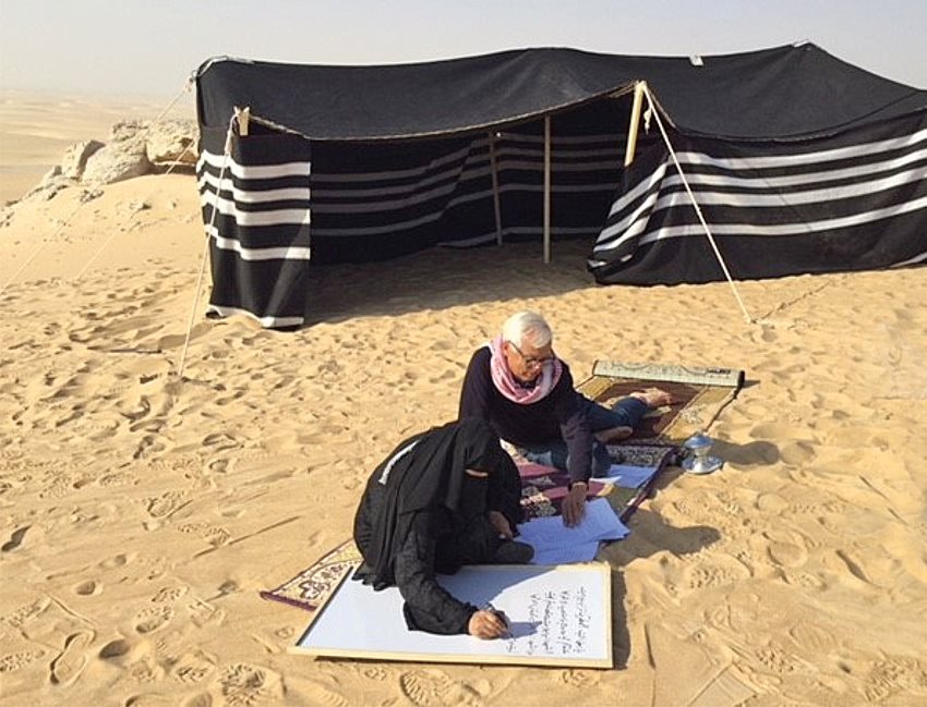 Poet Hissa Hilal, who won fame as one of the first female finalists on the televised Nabati contest Million’s Poet, writes down a poem outside a traditional Bedouin tent that was set up for al-Rahhalat al-Akhir in 2016. 