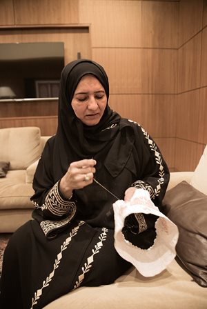 Safiya Ahmad Al Lawati, who oversees a growing network of women throughout Oman embroidering kummahs, hand-stitches one together herself in her home in Muscat, the Omani capital. For Al Lawati, a kummah, depending how intricate its design is can take up to a month to make.
