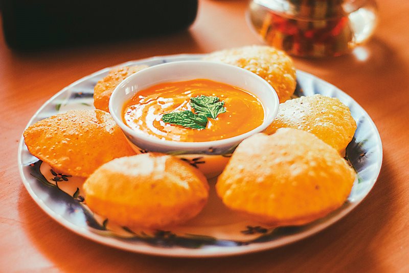 Puffy, crispy north Indian puris are served here with a mango-dip puree. 
