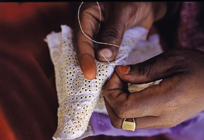 A close-up of a lady sewing a kummah in Zanzibar, where the introduction of the hat by Omanis have resulted in a set of designs unique to Zanzibar, with more perforations and available in a limited range of colors.
