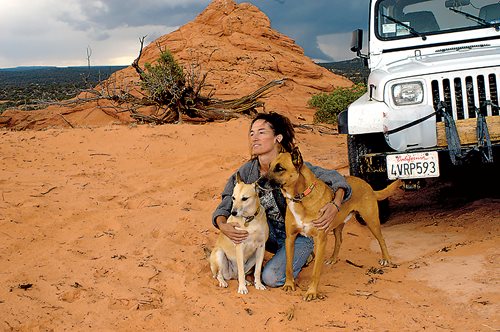 At a stop in Knab, Utah, Lorraine Chittock poses with her dogs and the Jeep Wrangler