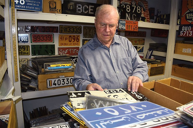 Plate collector Dick Parker sifts through his collection of more than 380 Middle Eastern plates at his home in Greenwich, Connecticut. “The most unique designs were from the Middle East and Latin America,” he says. 