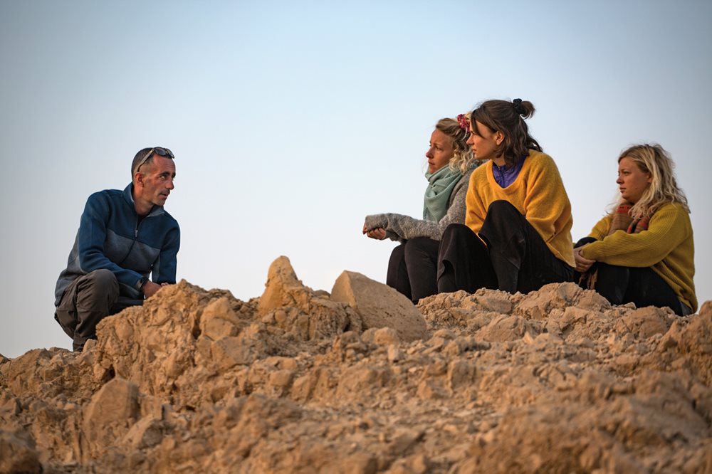On a clifftop overlooking the Dead Sea, guide George Giacaman chats with Danish hikers Laura Bendix Pedersen, Nina Timm Ifversen and Julie Nielsen.&nbsp;