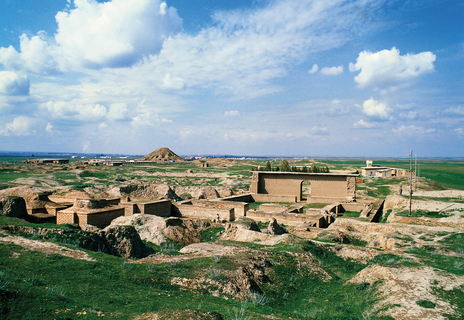 This contemporary view of Nimrud, on the Tigris River about 30 kilometers south of Mosul, looks to the northwest, over the Burnt Palace, with the North West Palace and ziggurat toward the background. When Austen Henry Layard began archeological exploration in 1845, the now-excavated ruins lay almost entirely buried.