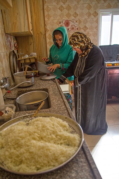 In the village of Tuqu&rsquo;, Um Naseem and her daughter Sajida prepare a meal for hikers.