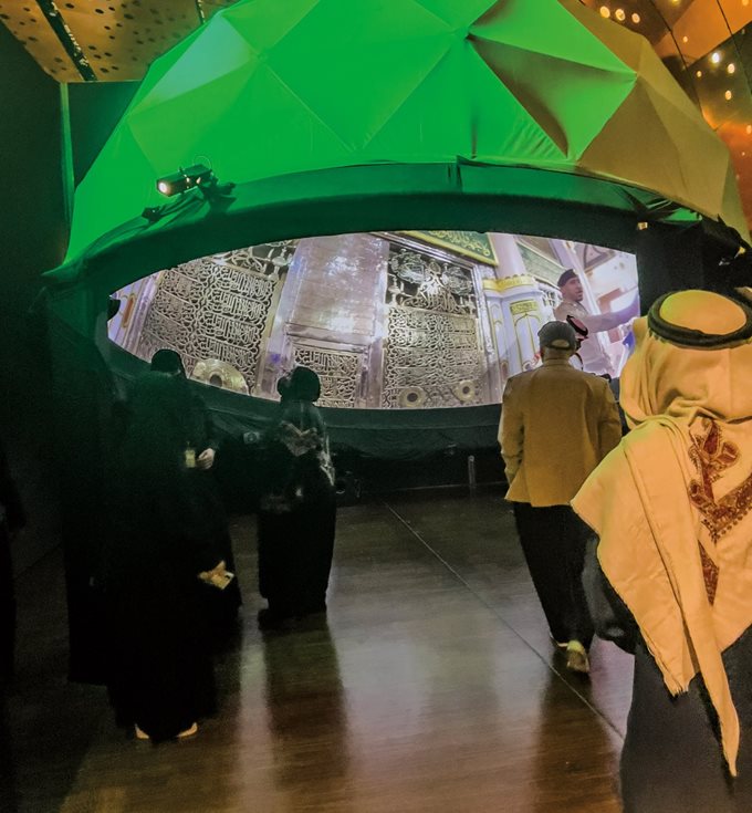 This evocation of the iconic green dome of the Prophet’s Mosque in Madinah closes “Hijrah: In the Footsteps of the Prophet” with video from inside the mosque, which includes the house of the Prophet with its own doors decorated in elegant calligraphy. 