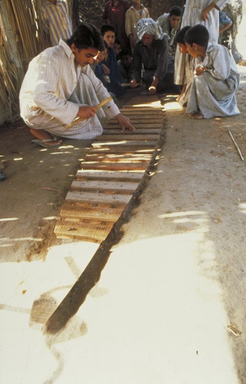 Arab craftsmen lay the poplar slats of a mushhuf.