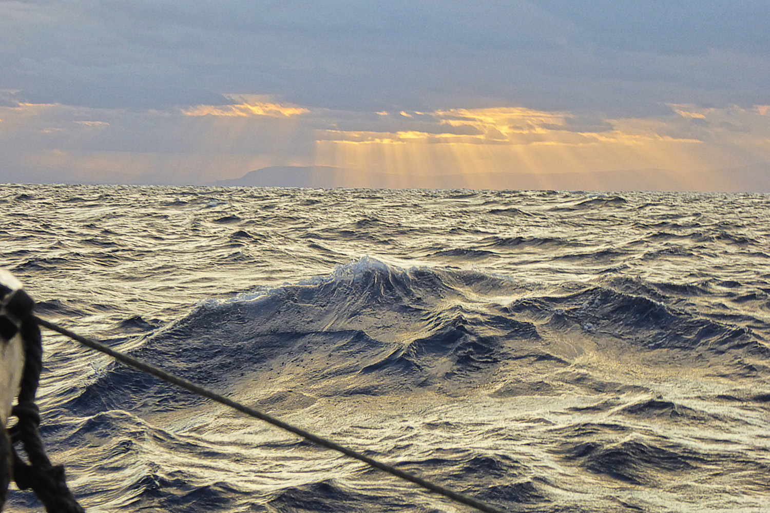 Sunlight gilded choppy waters as the Phoenica crossed the 59th meridian west into the Eastern Caribbean Islands. 
