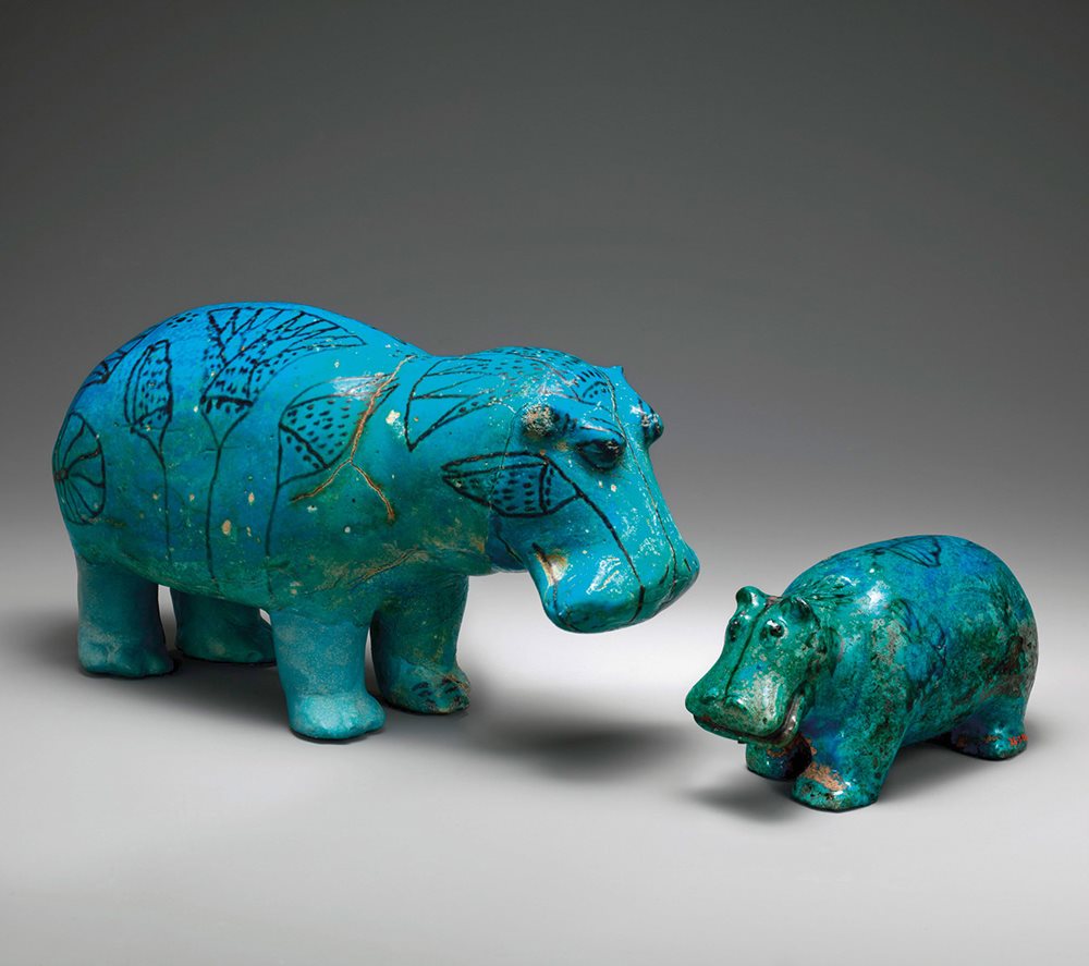 Roughly during the same era as the juglet above, ceramists figured out how to use powdered silica, quartz and other locally available agents to produce a brilliantly glazed blue ceramic that became known as faience, which remains glossy on both of these hippopotamus statuettes. Egyptians of the time regarded hippos as the deadliest inhabitants of the Nile, and the larger one&mdash;affectionately named William by the Metropolitan Museum of Art in New York&mdash;is among the finest examples of many faience animals that have been found in Egyptian tombs. (The smaller hippo is a bit older, from 1810-1700 BCE.) Both are decorated with designs of marsh plants, and on &ldquo;William,&rdquo; the lotus appears prominently.