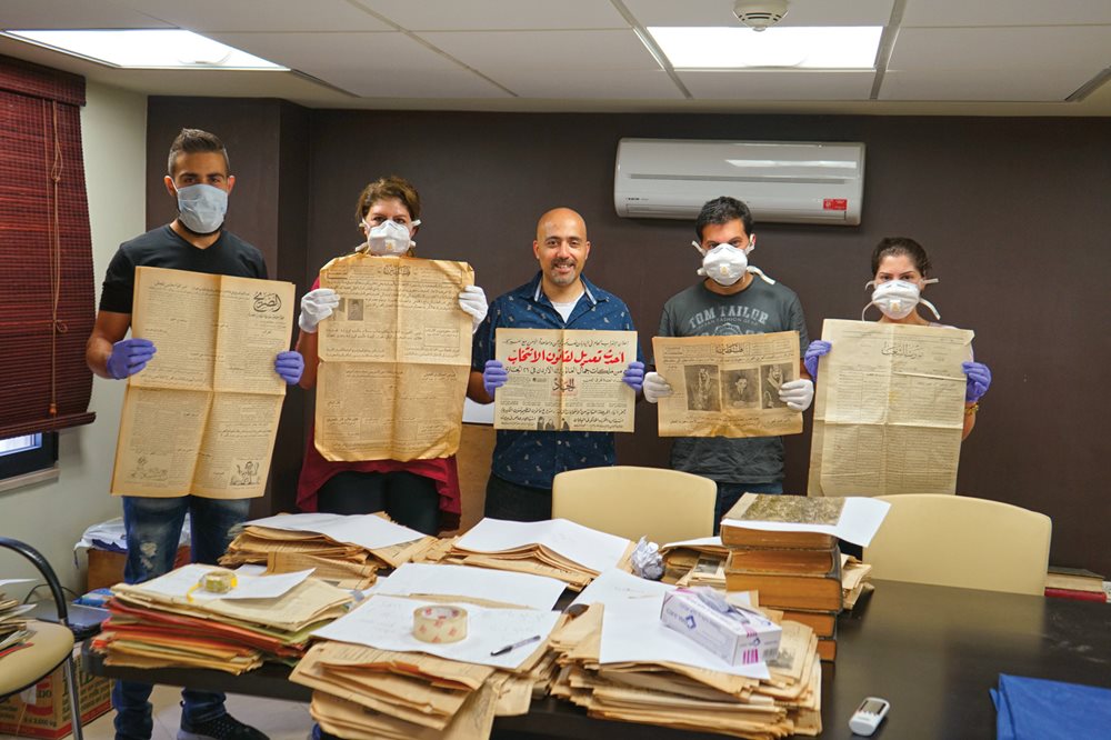 Donning gloves and masks, Dar Jacir staff and interns take on the delicate task of cataloging and archiving Dar Jacir’s extensive newspaper collection.