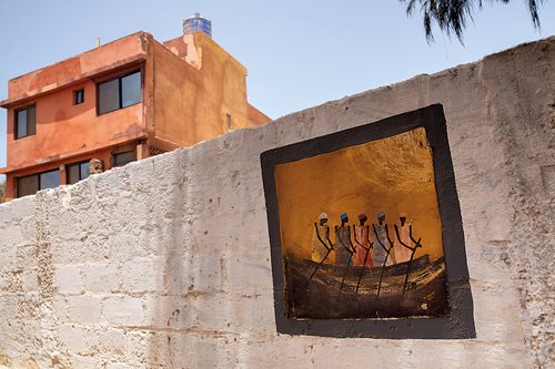 A painting on a wall outside a home on Ngor Island in Dakar depicts the prominence of pirogues throughout the Dakar region, where pirogues are also used for general transportation. Originally all were paddled; however, today most pirogues used for Atlantic fishing are fitted with outboard motors. 
