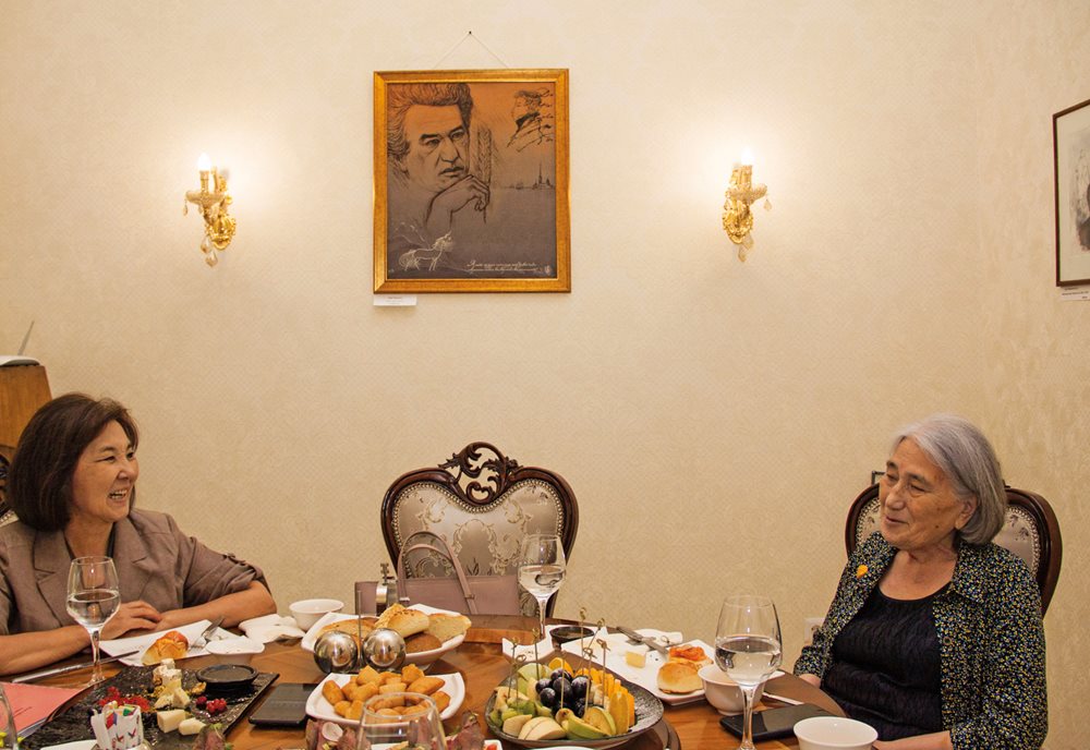 Roza Aitmatova, 81, and youngest sister of Chingiz Aitmatov, discusses family history with Gulnara Jamasheva of the Kyrgyz Academy of Sciences in a room of the Frunze Restaurant in Bishkek recently dedicated to the late author.