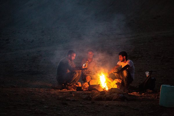 At nightfall, Farhan Ali Rashaydeh and other Bedouin guides on the Masar Ibrahim tend a campfire.