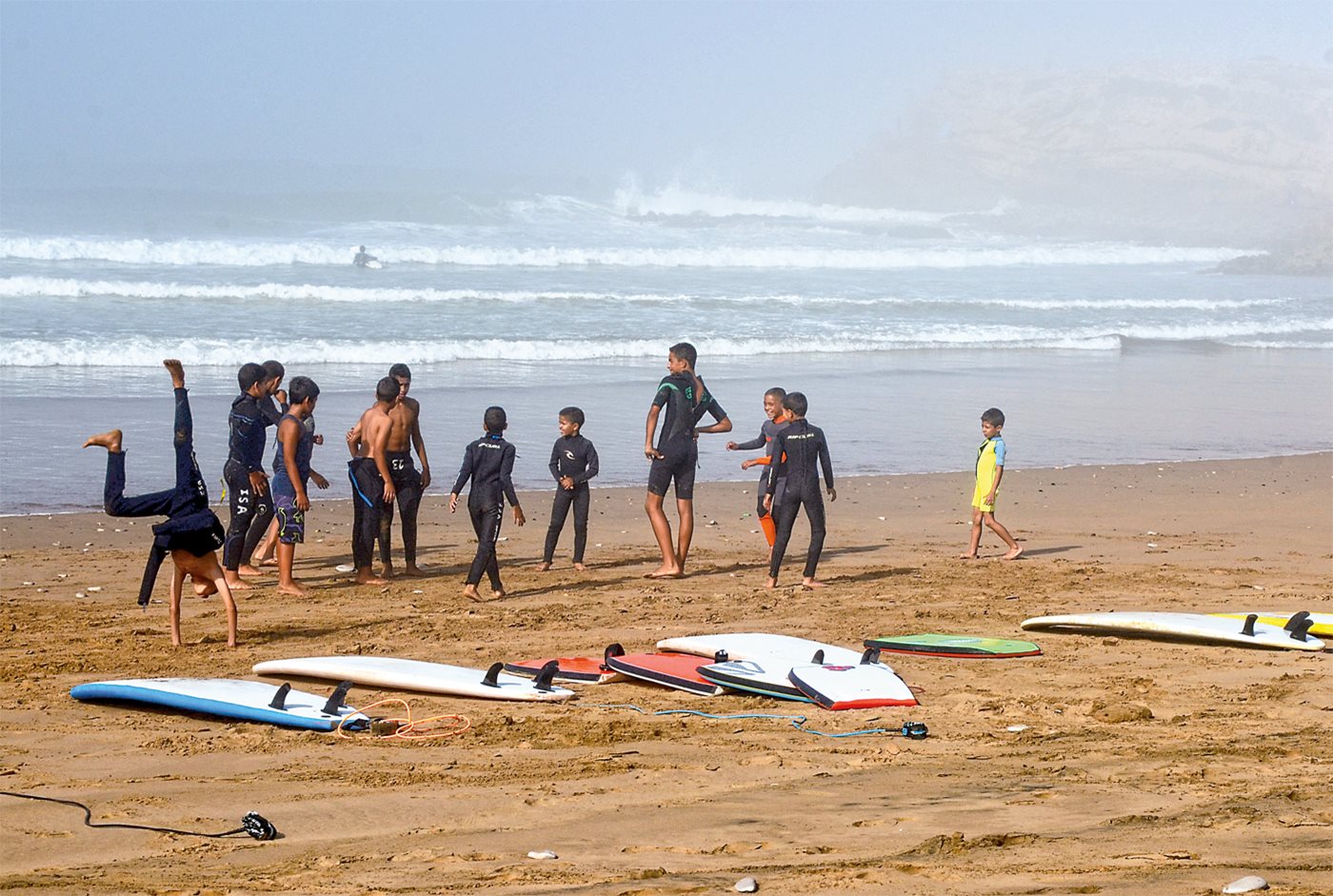 <p>The next generation of Moroccan surfers takes time out from the waves to play on the beach near Devil&rsquo;s Rock.</p>
