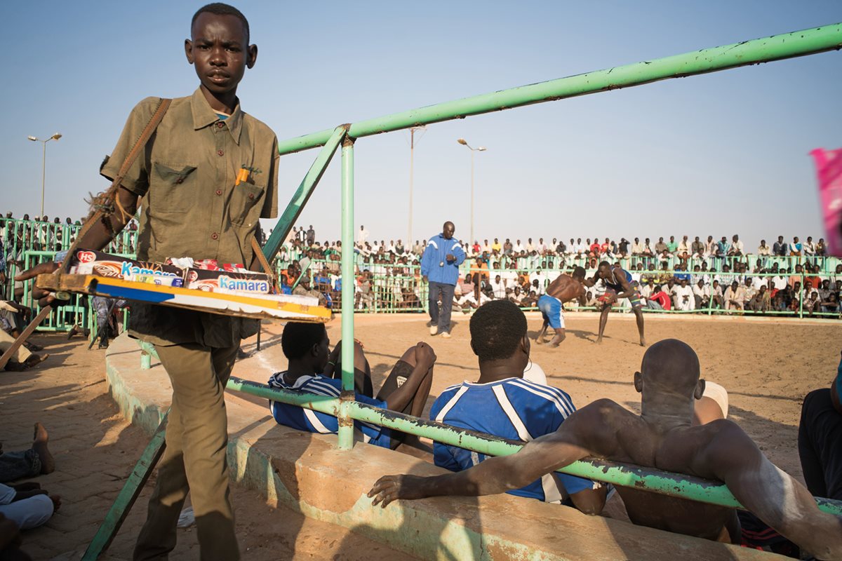 A vendor displays his wares at the weekly Nuba wrestling matches in Khartoum Bahri.