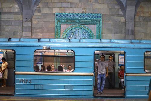Passengers wait for the doors to close at Alisher Navoiy station, named after the 15th-century founder of Uzbek language and literature.