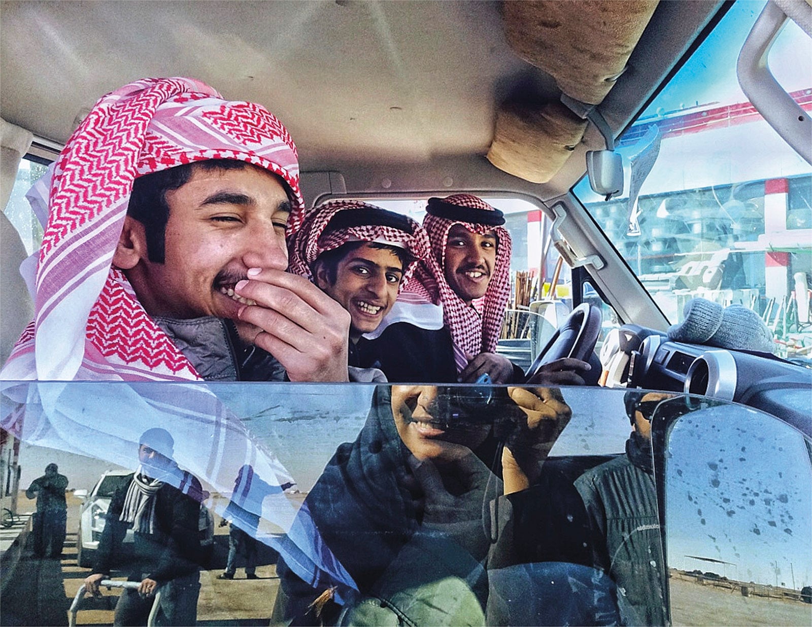 This image was taken when a couple of other photographers and myself attended the King Abdulaziz Camel Festival in 2018 in al-Rumahiyah, Saudi Arabia. We stopped in the middle of the desert to get some gas when I noticed this car of young Bedouin men. They looked like they were enjoying their journey, so I couldn’t resist. I walked up to them while taking photos until the teenager in the front felt a little embarrassed and started to laugh. I like this moment because it was real. They said they were on their way to the camel festival as well.