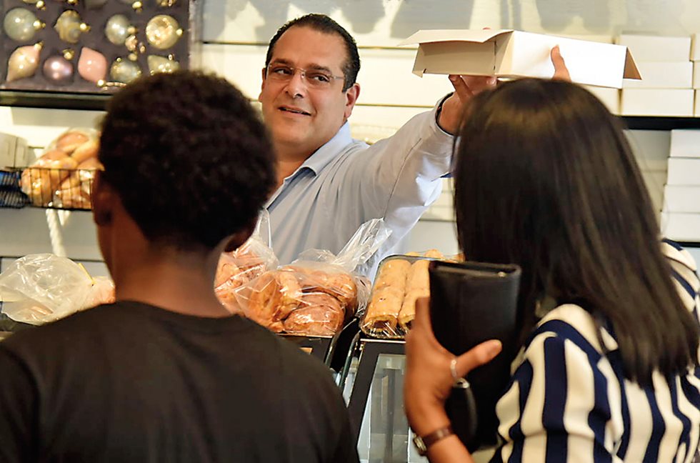 <p>Adam Abboud’s family-owned pastry shop in Port of Spain attracts a loyal clientele that comes for herbs and spices imported from Syria and Lebanon as well as uniquely local family recipes like Adam’s pepper sauce, which he tuned to Trinidadian tastes.</p>