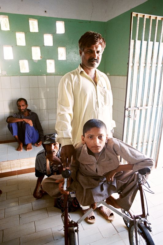 A handicapped child with an attendant at Edhi Village.