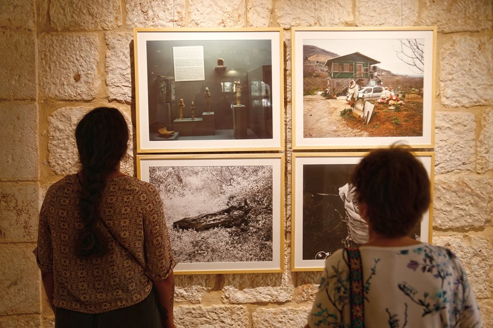 Attendees at Dar Jacir's inaugural exhibition in June view film stills from resident artist Jumana Manna. 