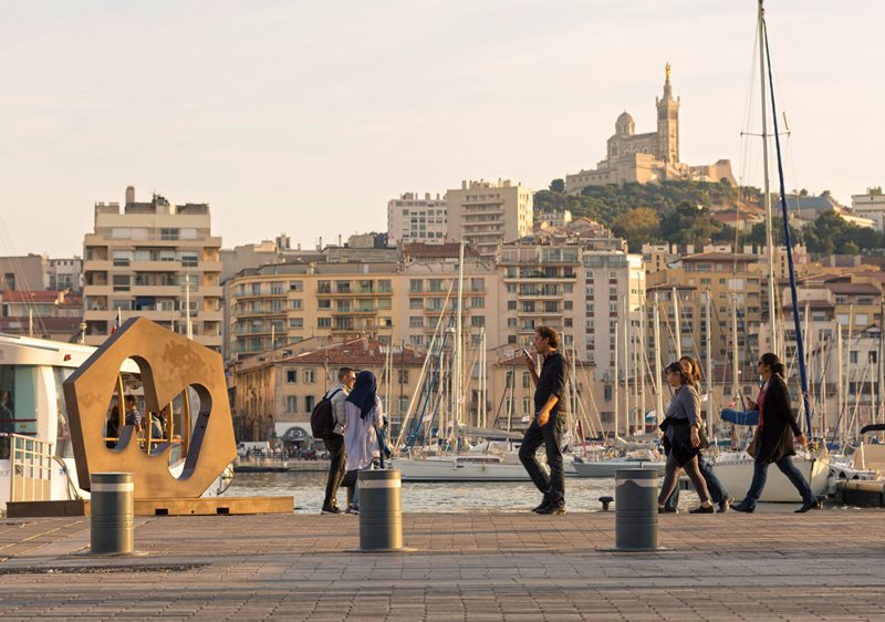 Residents walk along the Le Vieux Port (The Old Port), where for centuries people from across the Mediterranean stopped to trade&mdash;and where many began a longer journey, staying on and investing themselves in the fabric and future of France&rsquo;s third-largest city. &nbsp;