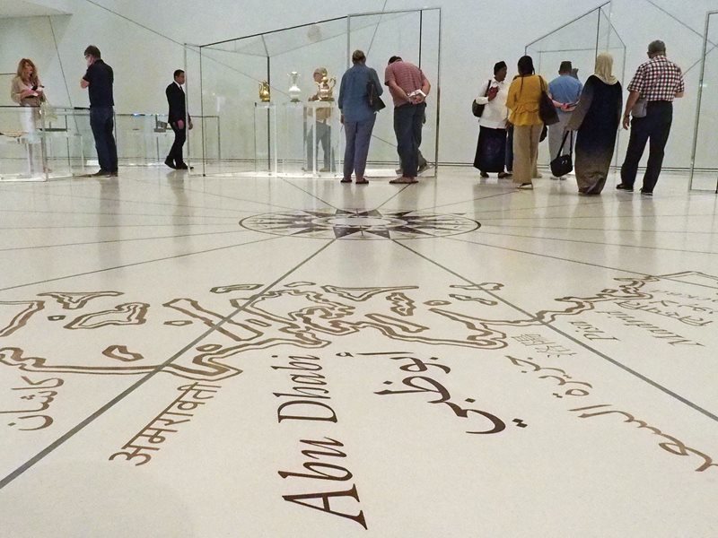 In the museum&rsquo;s Grand Vestibule an inlaid portolan map and compass rose announce a global scope while polygonal glass cases with sets of functionally similar objects&mdash;such as the decorative water vessels in the background&mdash;introduce the museum&rsquo;s theme of connections among cultures and civilizations.