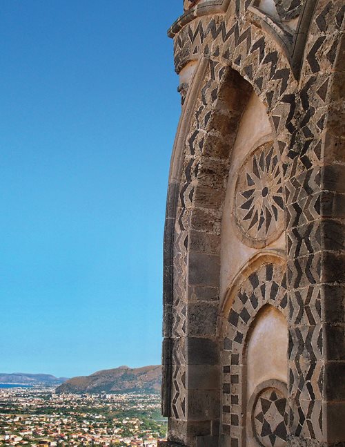 Overlooking Sicily’s capital of Palermo and its Conca d’Oro (Golden Basin), so named for the citrus groves introduced during two centuries of Arab rule, the peaked arches and geometric medallions on the apse of the Norman cathedral of Monreale testify to the layered culture of Arab Norman Sicily. 
