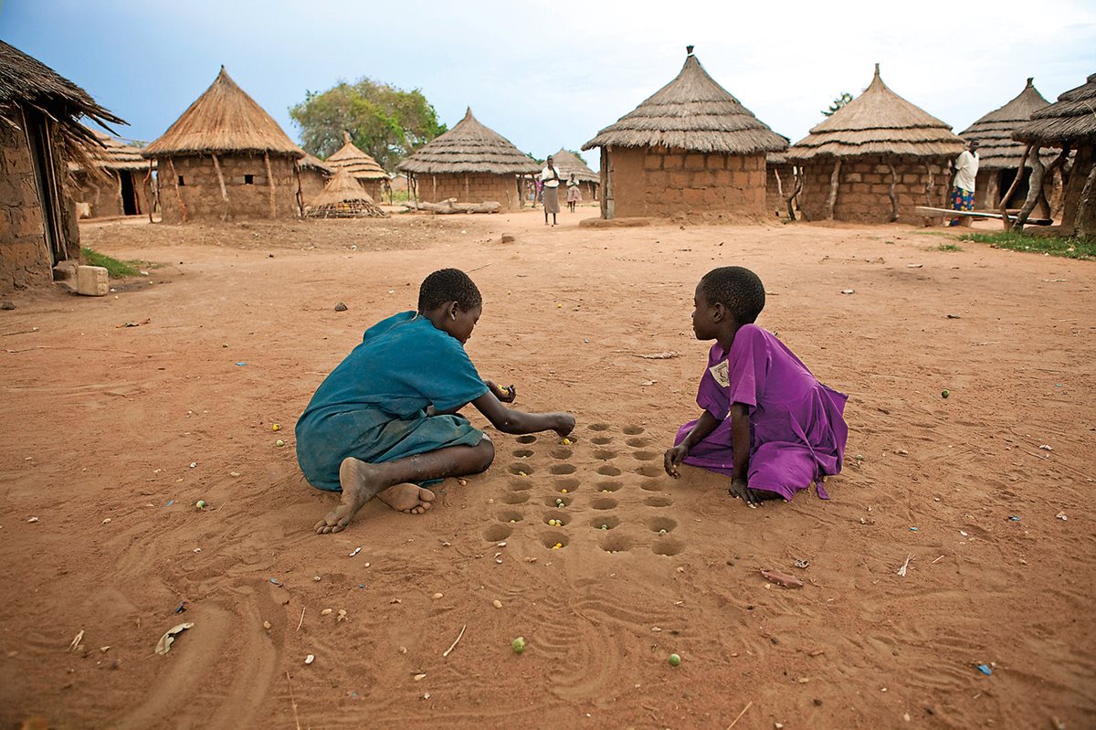 While portable and usually wooden mancala boards have rows of scooped-out circles in which players place and move their tokens—seeds, pebbles, shells, beads or what have you—the game’s origins likely hark back to roots as an East African analog for agriculture. Here, girls play in the Acowa refugee camp in northeast Uganda, where the game is sometimes called giuthi, meaning “to distribute” or “to place.”