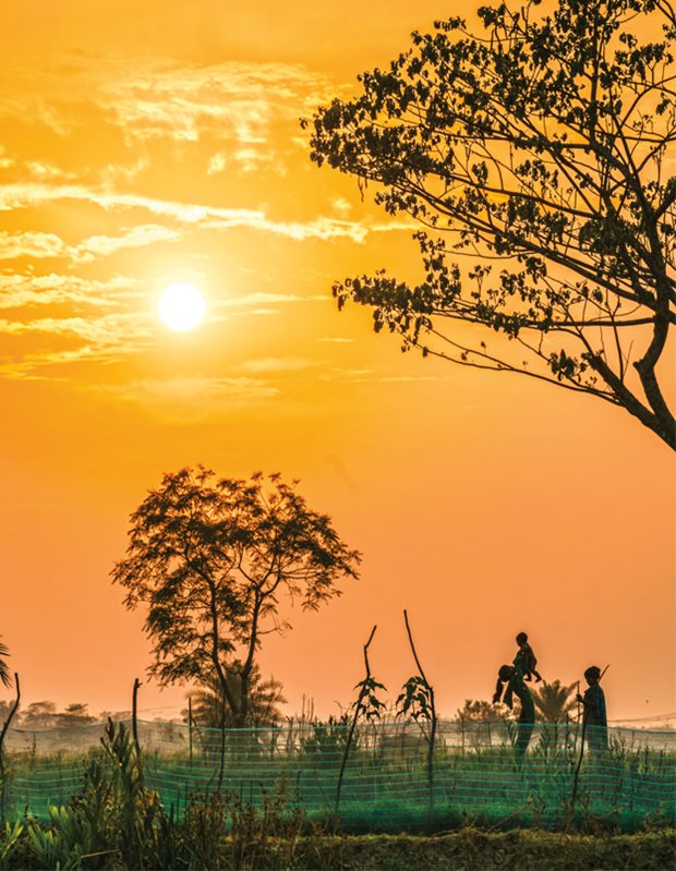 <p>In Laudope Union, Khulna District, a family plays as the sun sets.</p>
