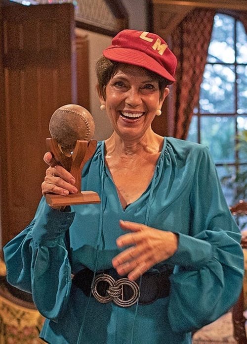 Peggy Karam holds a ball preserved amid her father's collection and wears his hat with “LM” on it, which stands for L’Monar (Guiding Light). “Some of my earliest memories are of watching Pop play baseball,” she says, and it was at a convention of the Southern Federation that she met Richard Karam, her husband of 44 years, right, whose father also played in the league. Richard holds a uniform from the Syrian Lebanese league’s San Antonio team whose letters “ame syr” stand for “American Syrians.”